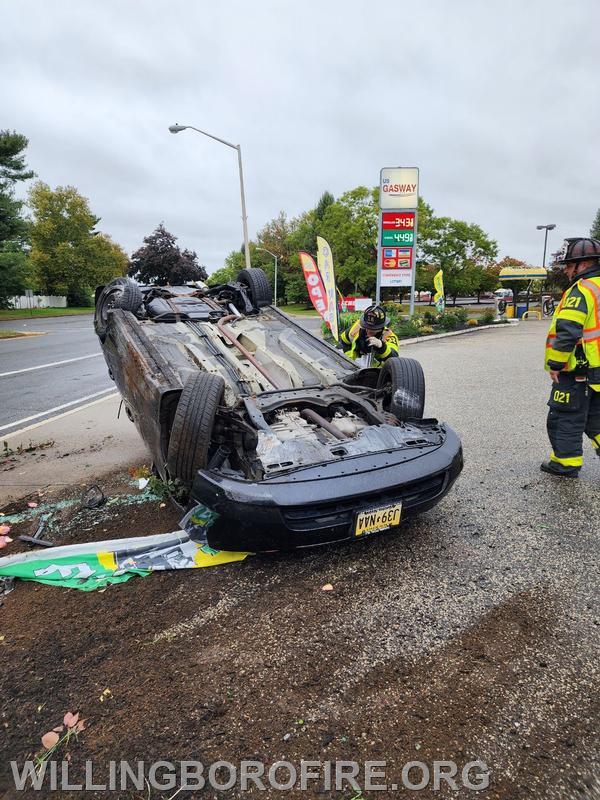 Crews securing an overturned vehicle.