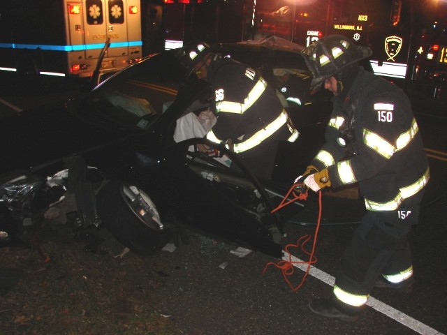 Firefighters Ferrell (l) and Rydarowski (r) use the Jaws of Life to free a trapped driver from a motor vehicle accident