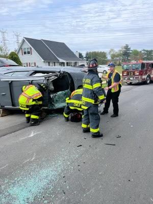 Captain Fresco overseeing operations on scene of an overturned vehicle with someone trapped.