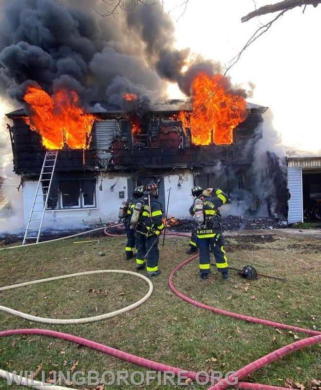 Firefighters D. O'Donnell and E. O'Donnell making entry on a dwelling fire while Captain Costello had command.