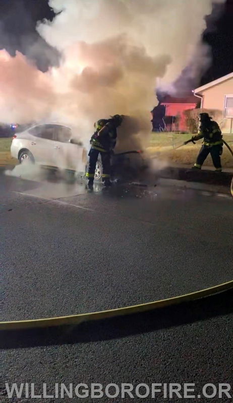 Firefighters LeHuquet and Connelly operating on an auto fire.