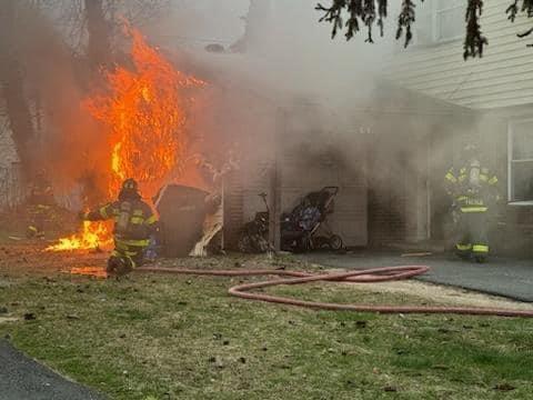 Firefighter Sierra deploying the 1 3/4&quot; handline to extinguish a garage fire.