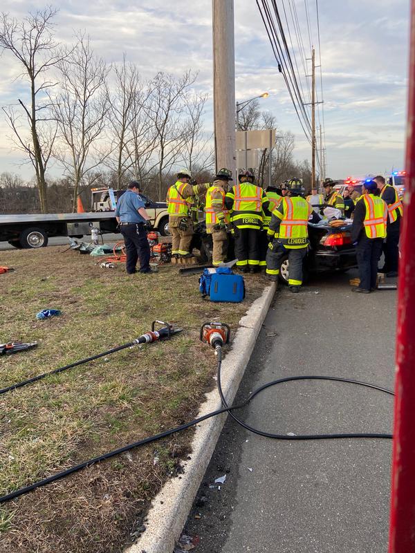 Crews extricating a person trapped in a vehicle.