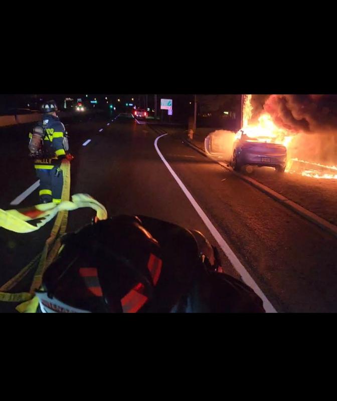 Firefighter Connelly and Lieutenant O'Donnell stretching a line on an auto fire.