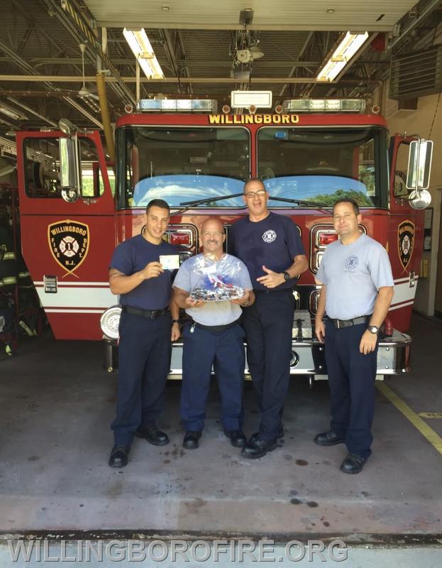 Firefighter Centrone, Captain Ramsey, Firefighter Anderson, and Lieutenant Friddell in front of 1613.