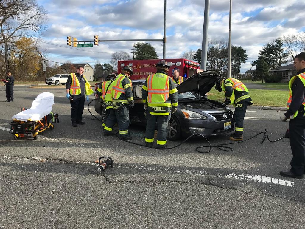 Firefighters extricating one patient who was trapped in their vehicle from an accident.