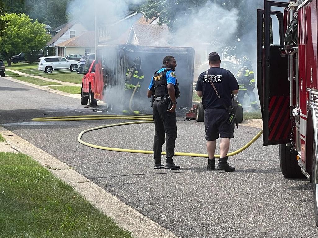 Firefighters Barger and Connelly extinguishing a landscape trailer fire.