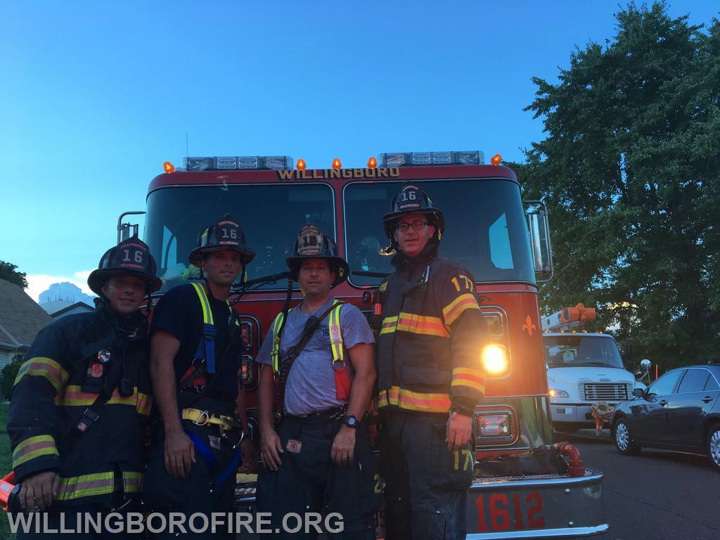 Firefighters Centrone, Priest, Lieutenant Friddell, and Firefighter Anderson in front of Engine 1612.