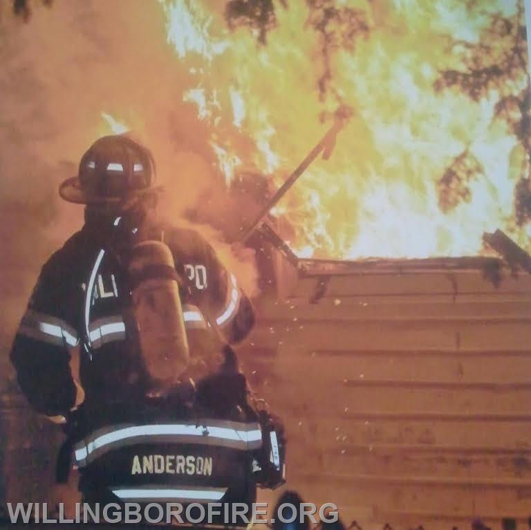 Firefighter Anderson venting a window.