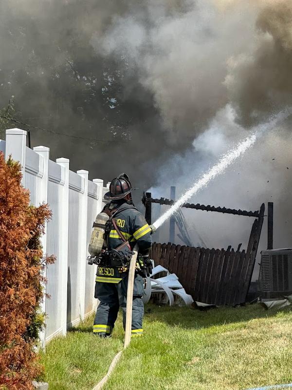 Captain Fresco extinguishing exterior fire at an all hands fire in Garfield Park.