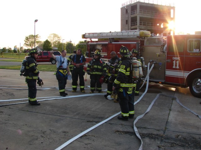 Captain Sitzenstock explains the drill to the firefighters